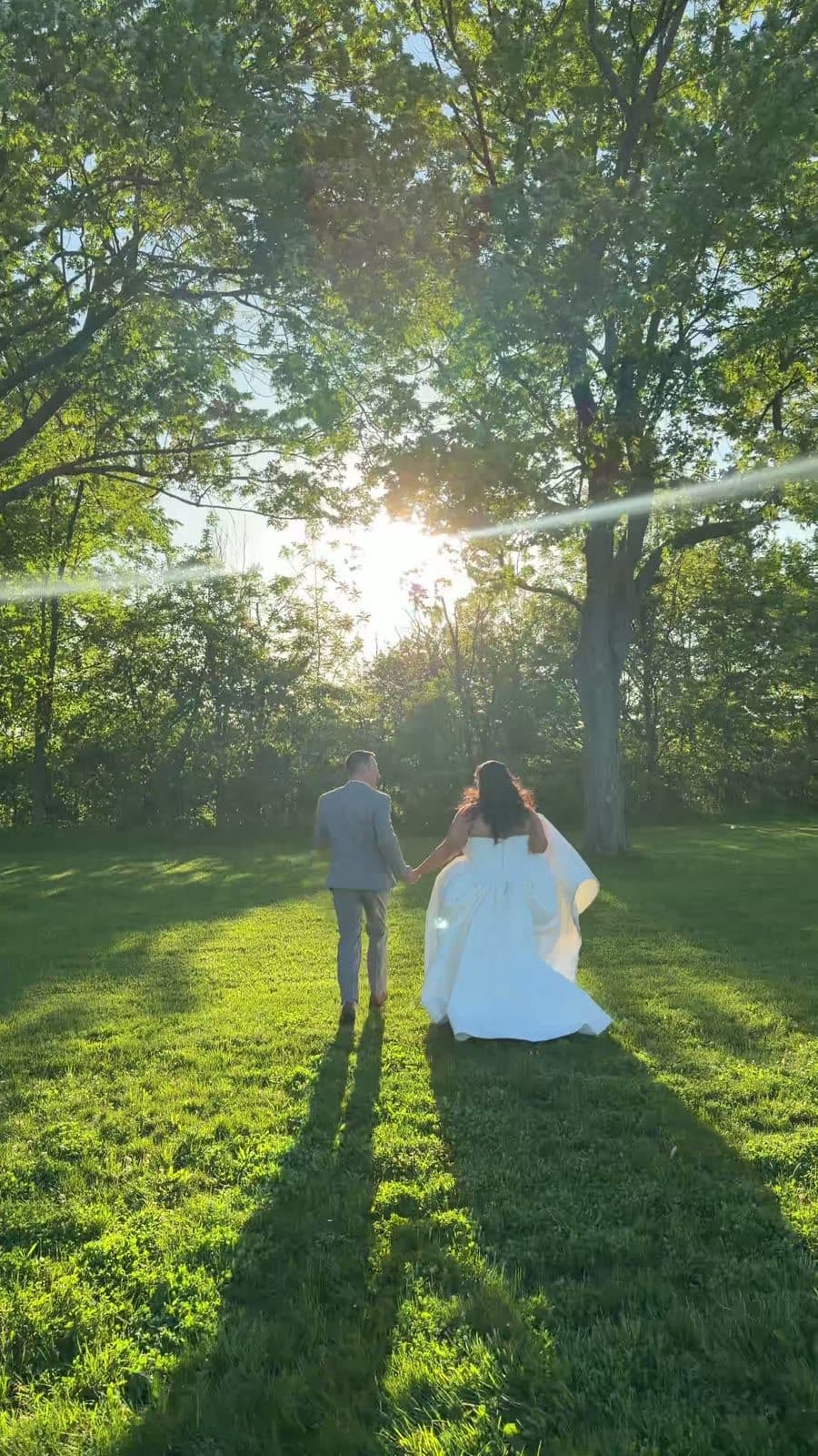 A newly married couple walking together at golden hour
