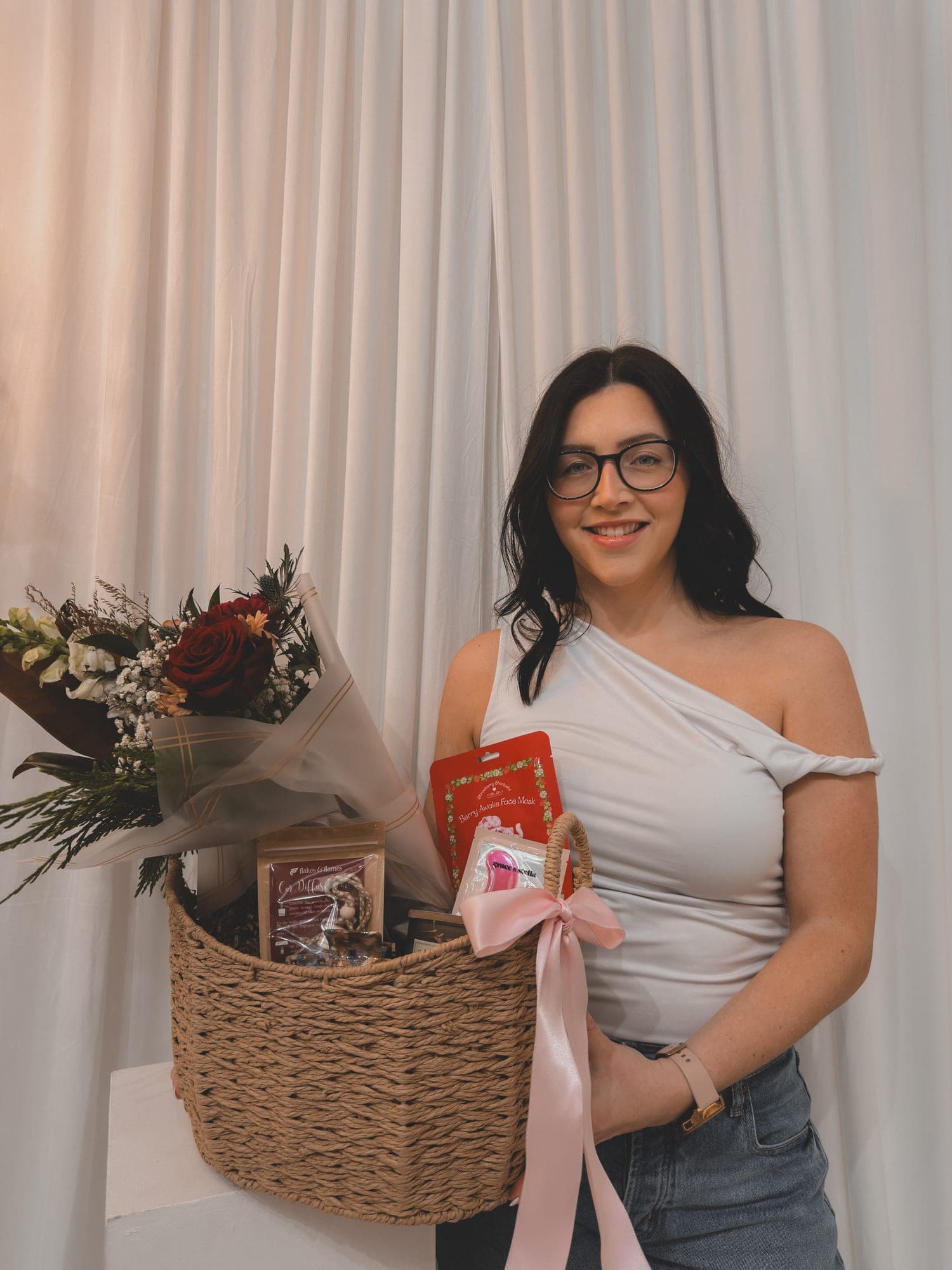 The Krafted Designs owner holding one of her gift baskets