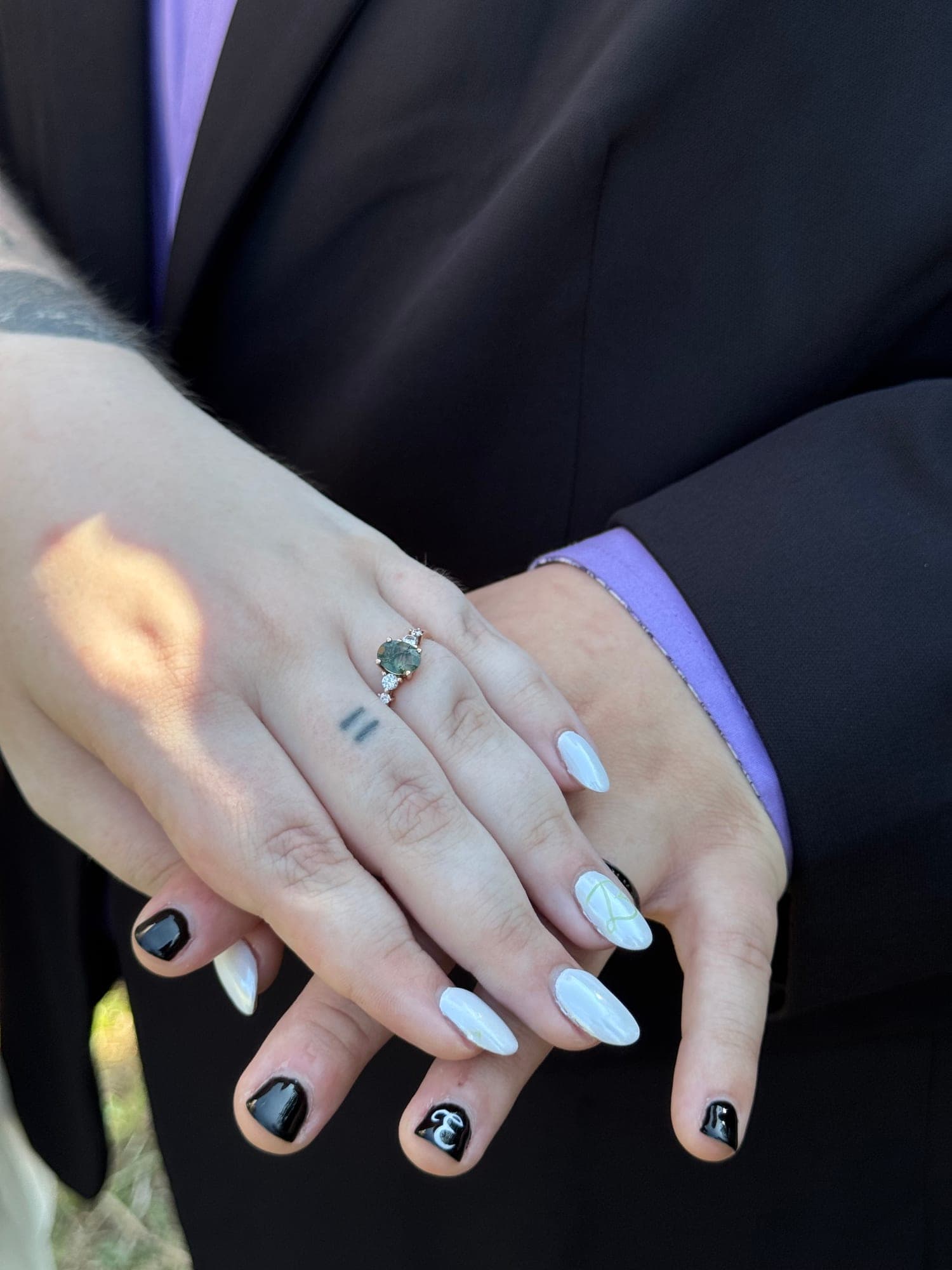A close candid view of a couple's hands and new rings on their wedding day