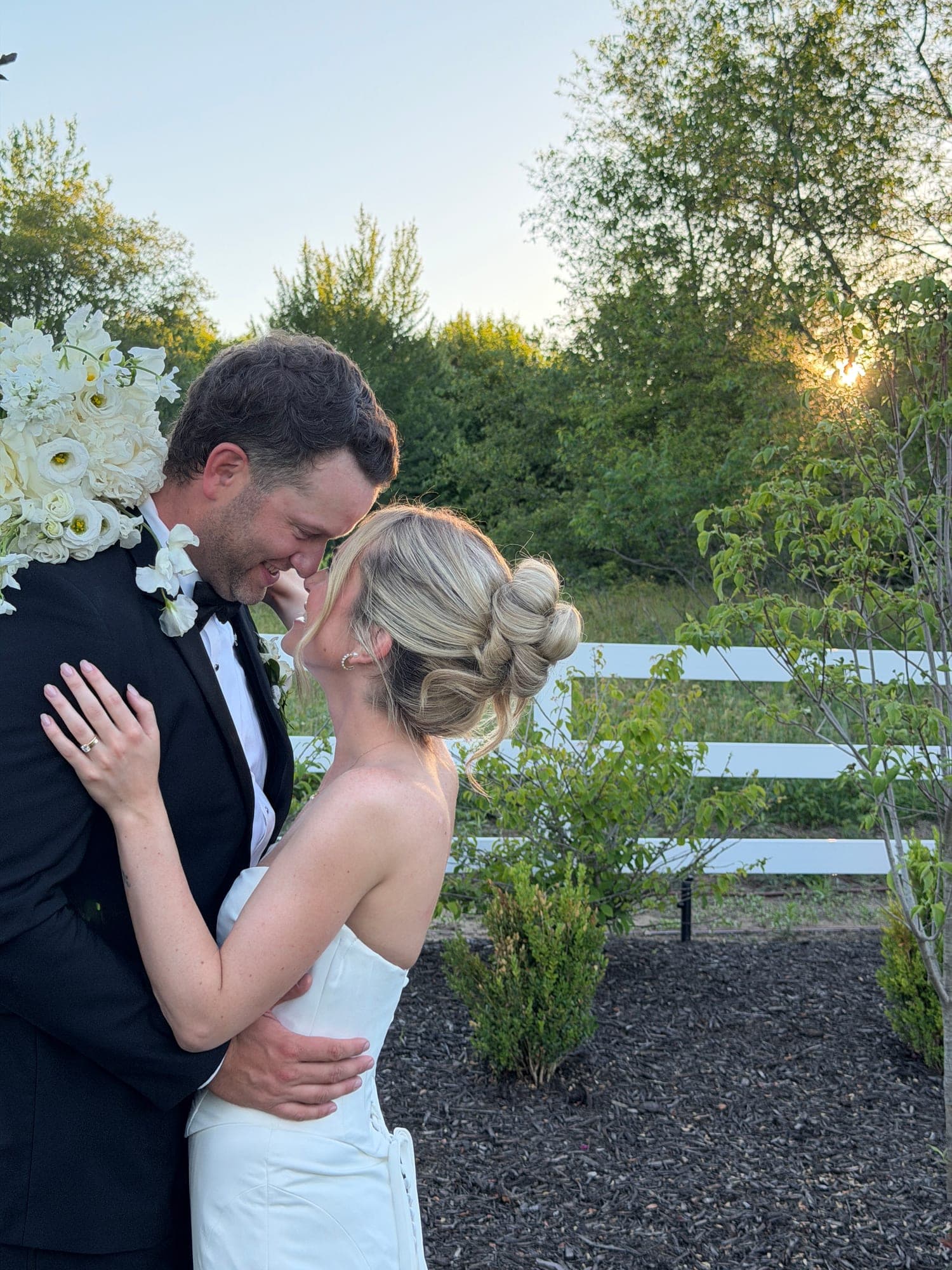 Riley and Austin forehead to forehead as the sun sets behind them